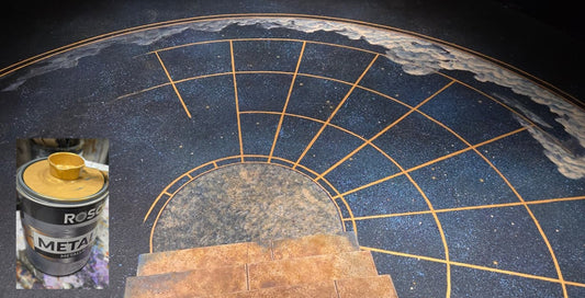 Wide view of a stage floor hand-painted with a gold star-chart design in Rosco Metallix